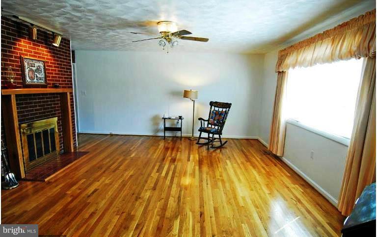 321 Brock Bridge Road Laurel, MD 20724 - Photo 5 of 20 a view of a room with wooden floor and staircase