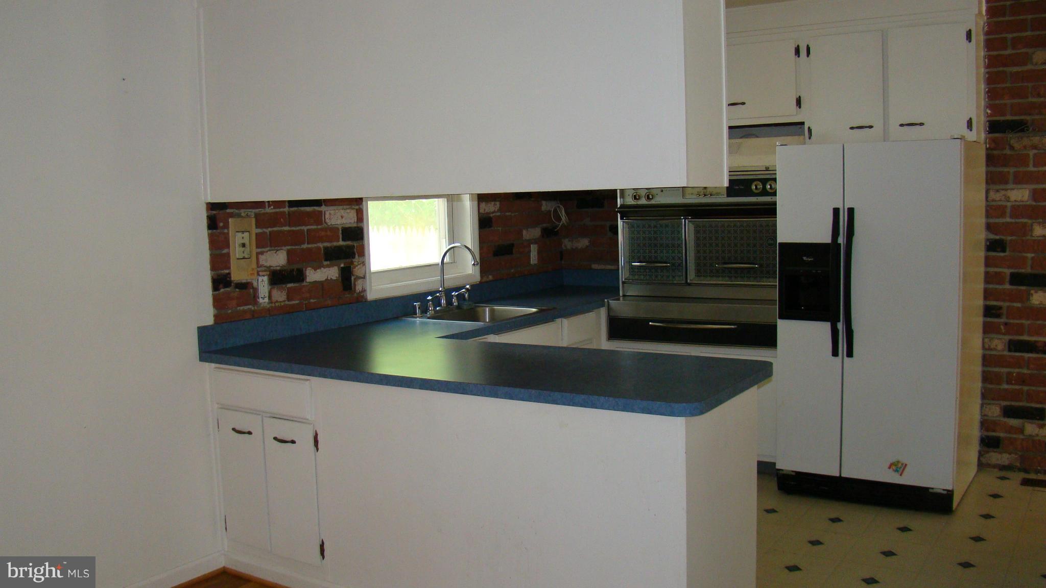 321 Brock Bridge Road Laurel, MD 20724 - Photo 6 of 20 a kitchen with stainless steel appliances a sink and a refrigerator
