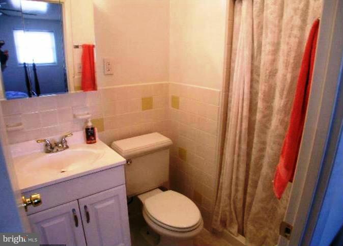 321 Brock Bridge Road Laurel, MD 20724 - Photo 10 of 20 a bathroom with a sink a toilet and a mirror