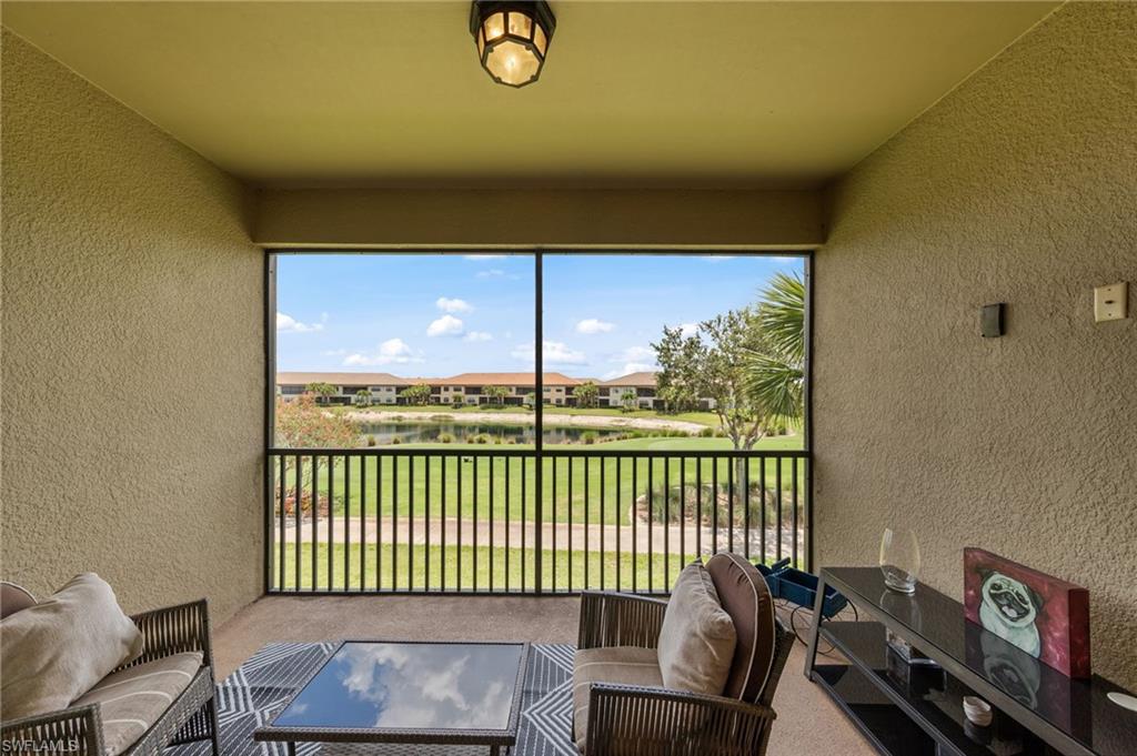 9366 Pocida Court, Unit 202 Naples, FL 34119 - Photo 24 of 44 a view of a chair and table in balcony