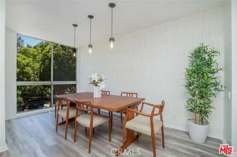 a large kitchen with stainless steel appliances granite countertop a lot of counter space and wooden floors