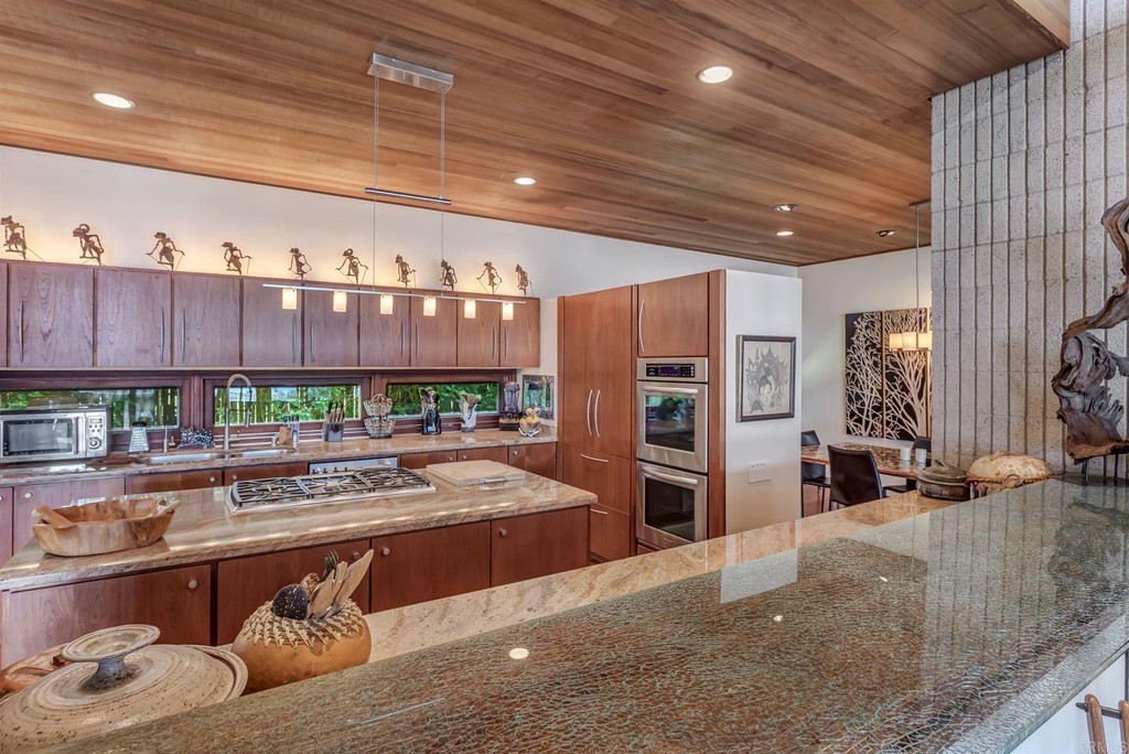 2054 Sheridan Road Encinitas, CA 92024 - Photo 17 of 58 a living room with stainless steel appliances kitchen island granite countertop furniture and a kitchen view