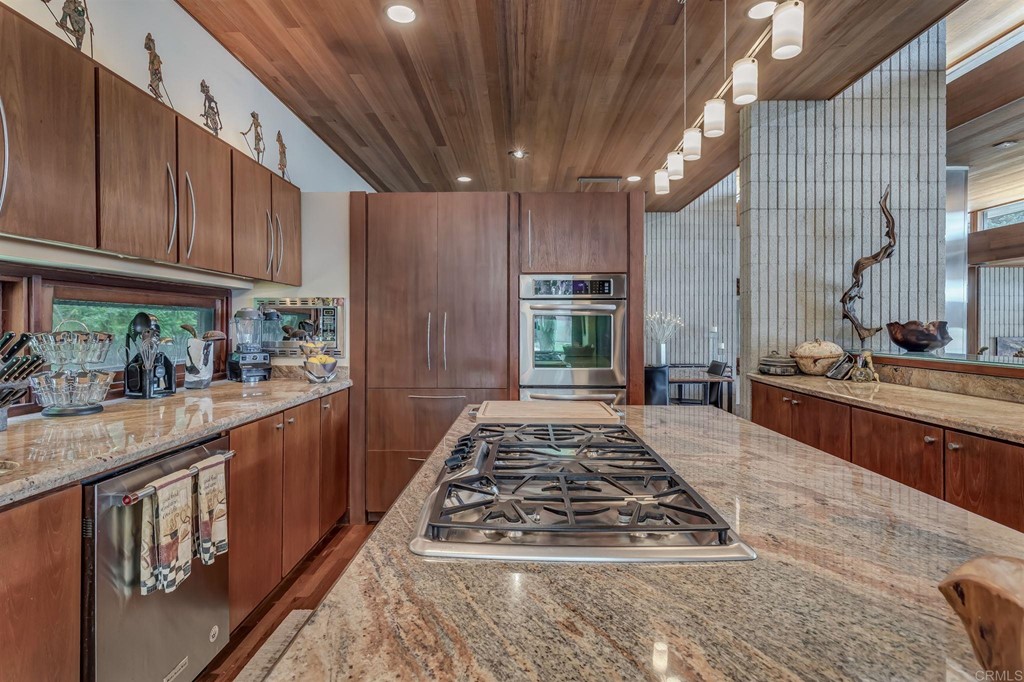 2054 Sheridan Road Encinitas, CA 92024 - Photo 18 of 58 a kitchen with stainless steel appliances granite countertop a stove a sink dishwasher and cabinets with wooden floor