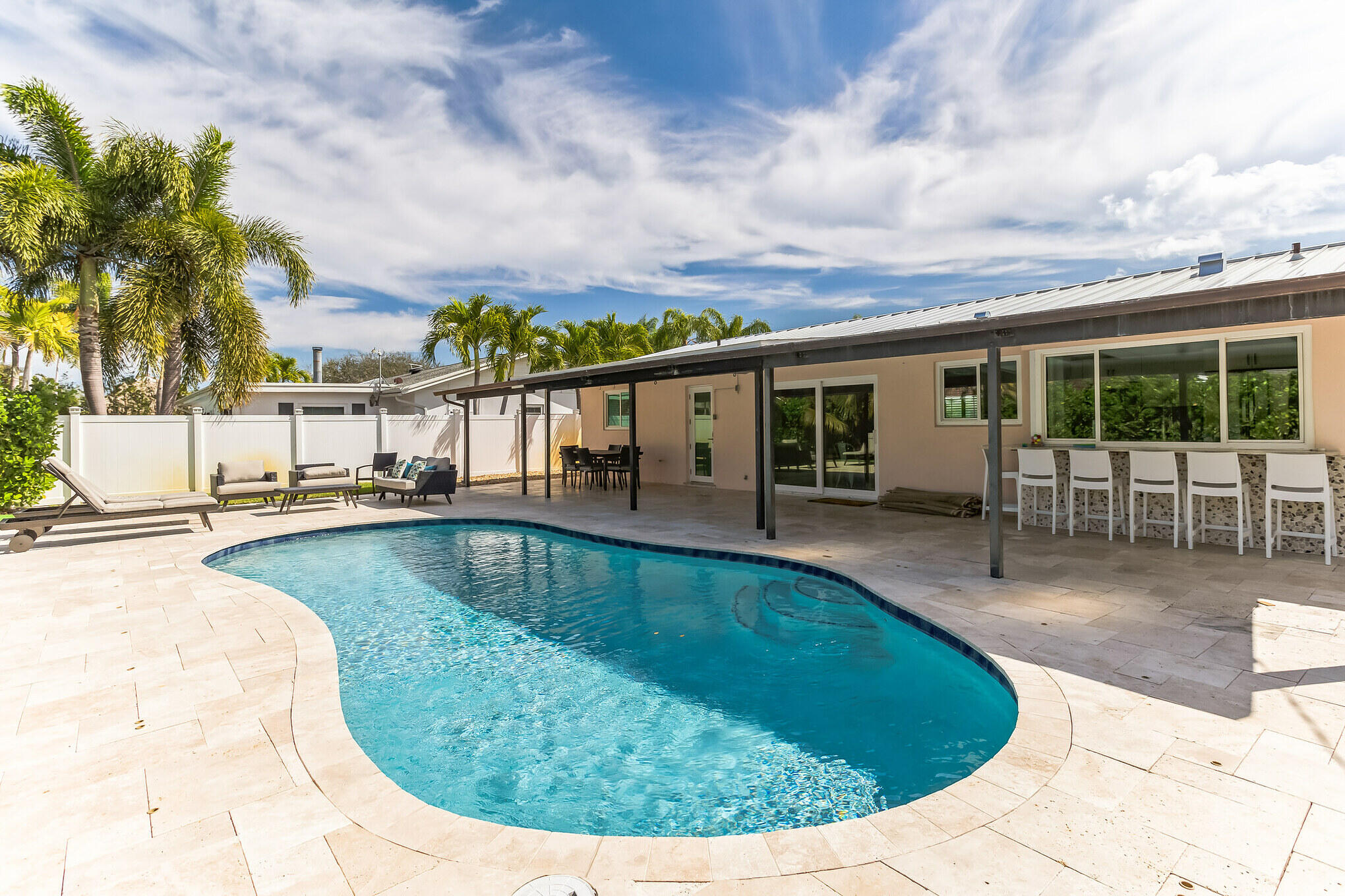 19 Willow Road Tequesta, FL 33469 - Photo 1 of 31 a view of a swimming pool with a patio