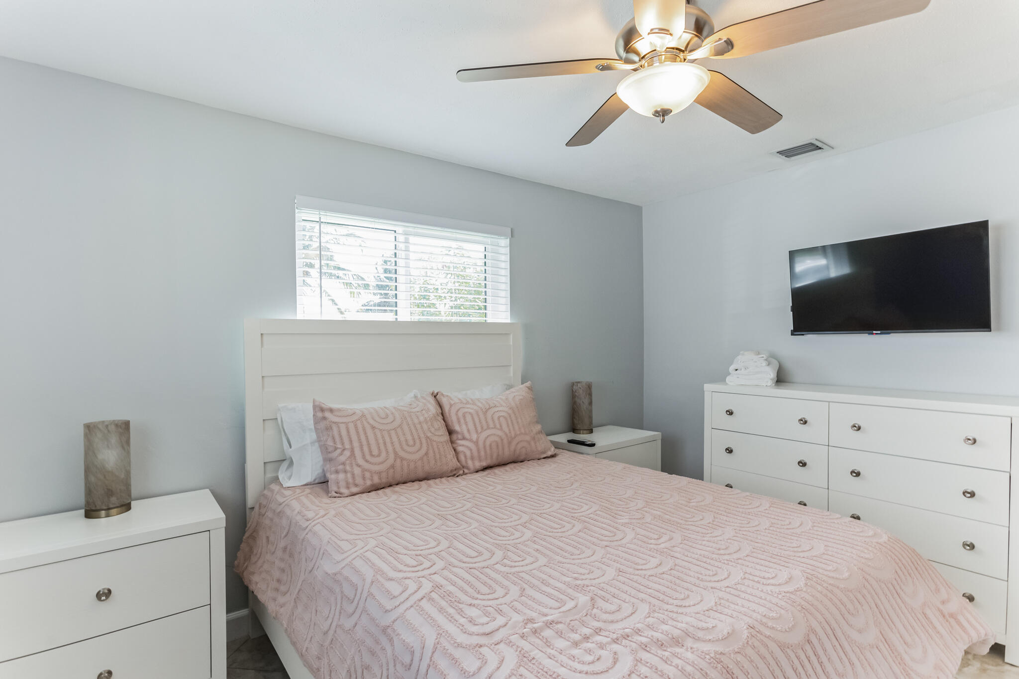 19 Willow Road Tequesta, FL 33469 - Photo 21 of 31 a bedroom with a bed and flat screen tv