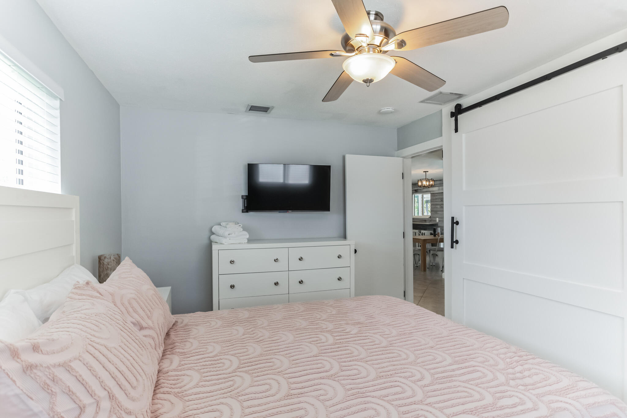 19 Willow Road Tequesta, FL 33469 - Photo 22 of 31 a bedroom with a bed and a flat screen tv