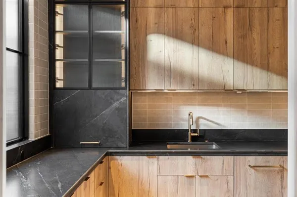 a kitchen with stainless steel appliances a sink stove and cabinets