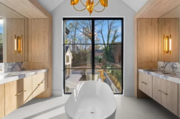 an empty room with wooden floor fireplace and windows