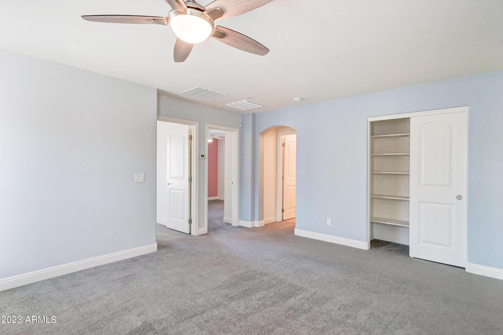 2297 North Alsap Road Buckeye, AZ 85396 - Photo 12 of 36 a view of an empty room with a ceiling fan