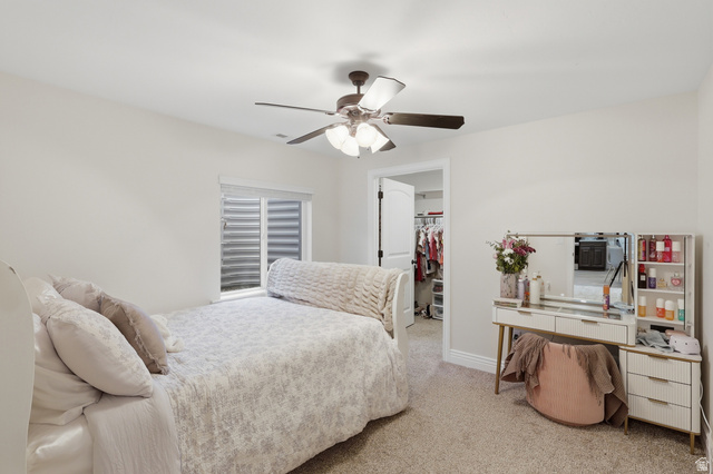 10676 Urban Rdg Cove South Jordan, UT 84095 - Photo 18 of 48 Carpeted room featuring a ceiling fan with integrated lighting, a window with horizontal blinds, and a doorway revealing a closet with built-in shelving