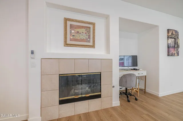 a living room with furniture kitchen view and a potted plant