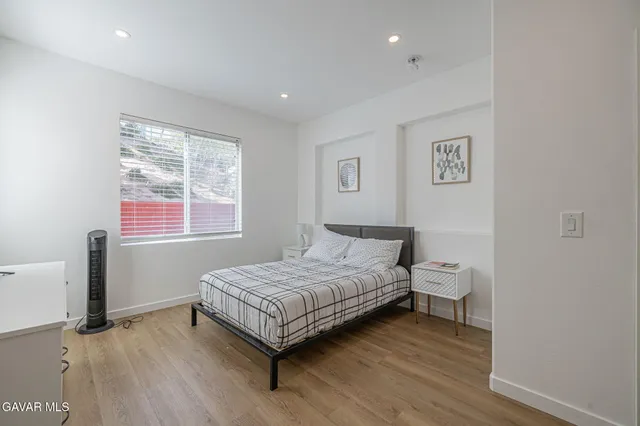 a bedroom with a bed and a television