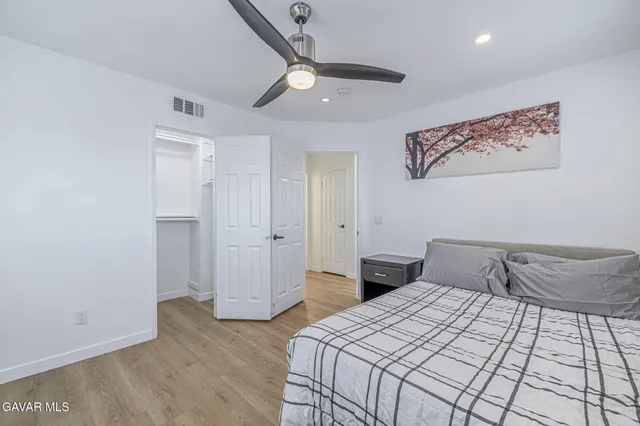 a bedroom with a large bed and a chandelier