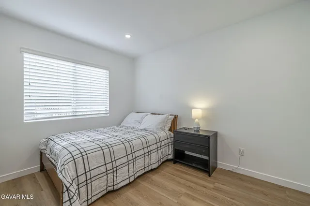 a spacious bedroom with a bed and a table in it