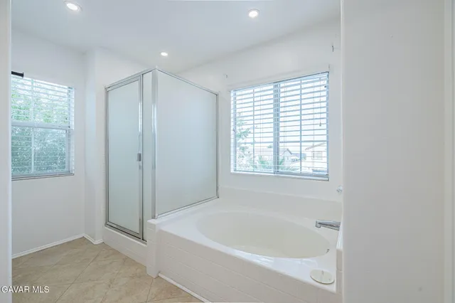 a view of a bathroom with sink cabinet and a living room