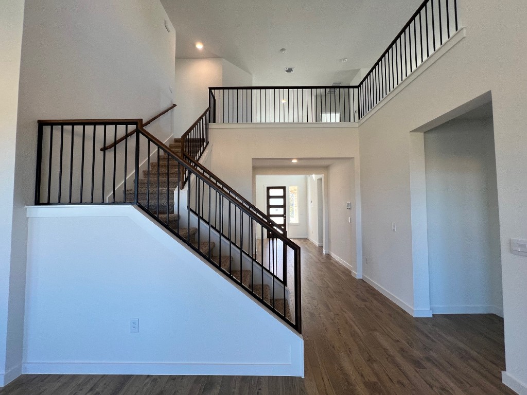 512 Prairie Wind Drive Leander, TX 78641 - Photo 6 of 10 a view of staircase with wooden floor and fan