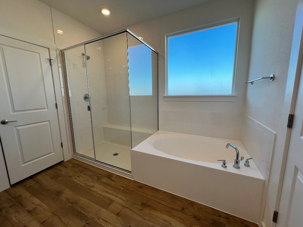 512 Prairie Wind Drive Leander, TX 78641 - Photo 7 of 10 a bathroom with a bathtub and a shower