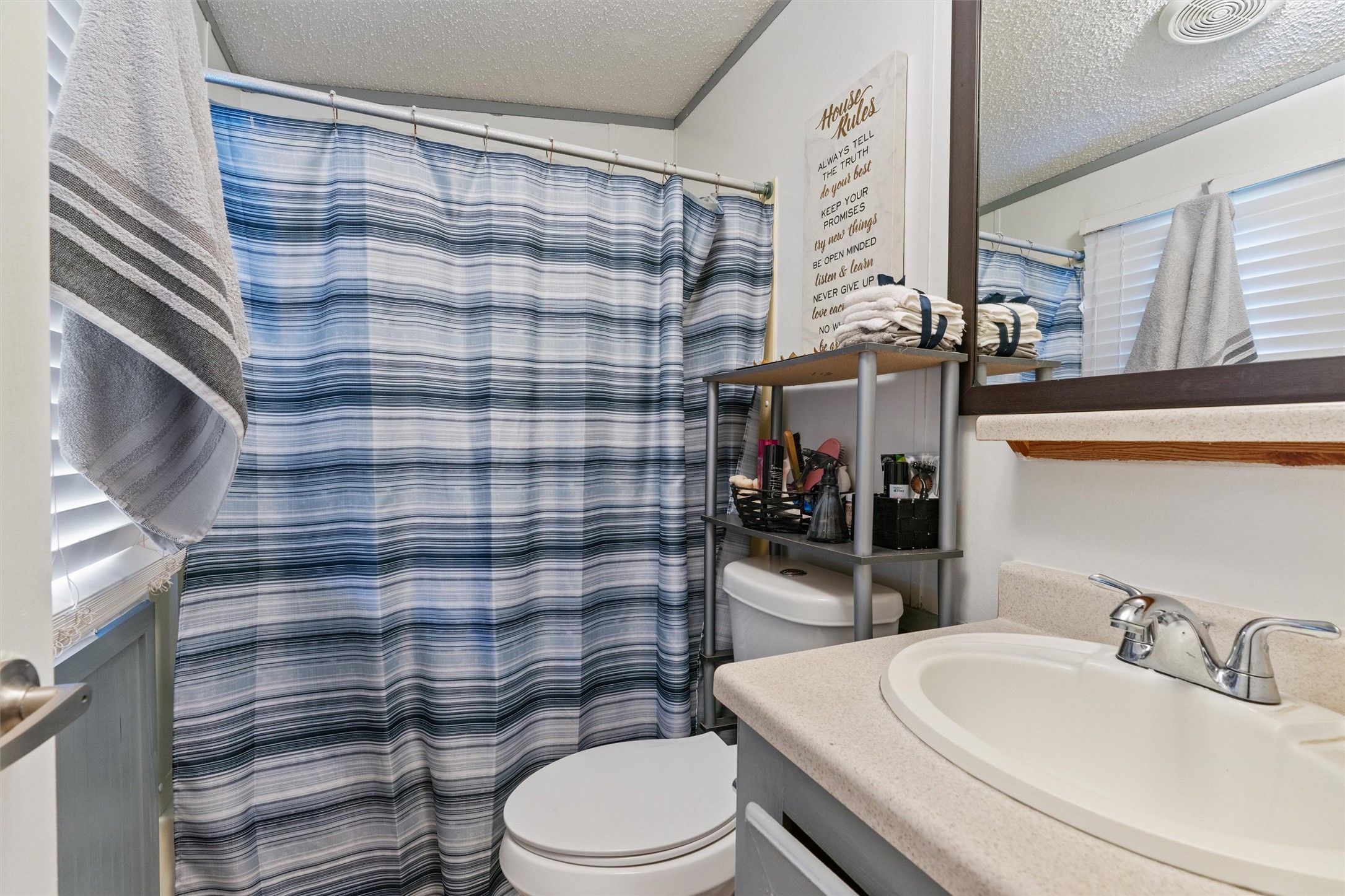 218 Boxcar Path Kyle, TX 78640 - Photo 10 of 21 Functional full bathroom featuring a tub-shower combination, modern vanity, and a mirror.