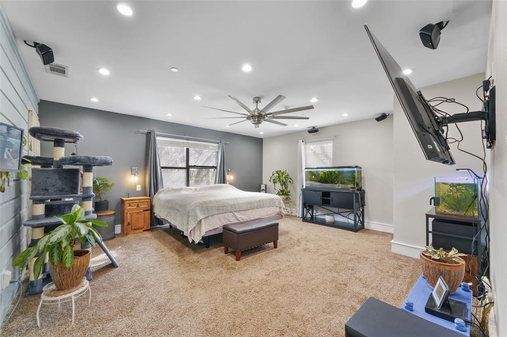 1051 Lynch Bend Road Springtown, TX 76082 - Photo 2 of 39 a spacious bedroom with a bed a couch and dresser
