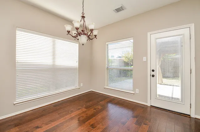 a kitchen with granite countertop wooden cabinets a stove a sink and dishwasher