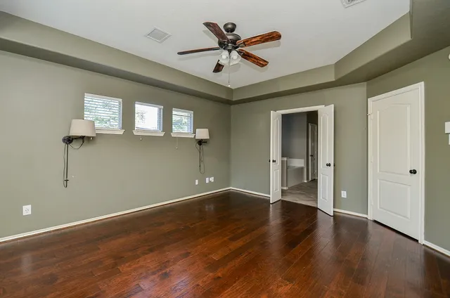 a spacious bathroom with a granite countertop tub sink shower and mirror