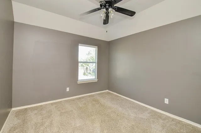 a view of bathroom with a sink and mirror with toilet