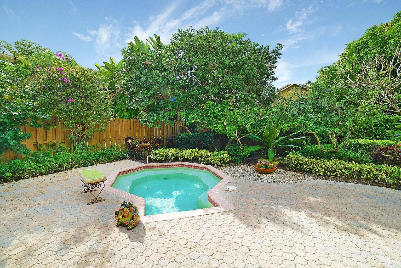 6695 Northwest 25th Court Boca Raton, FL 33496 - Photo 23 of 40 a view of a swimming pool with a patio