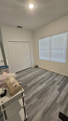 a view of a room with wooden floor