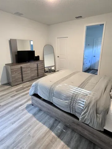 a bedroom with a bed and a lamp