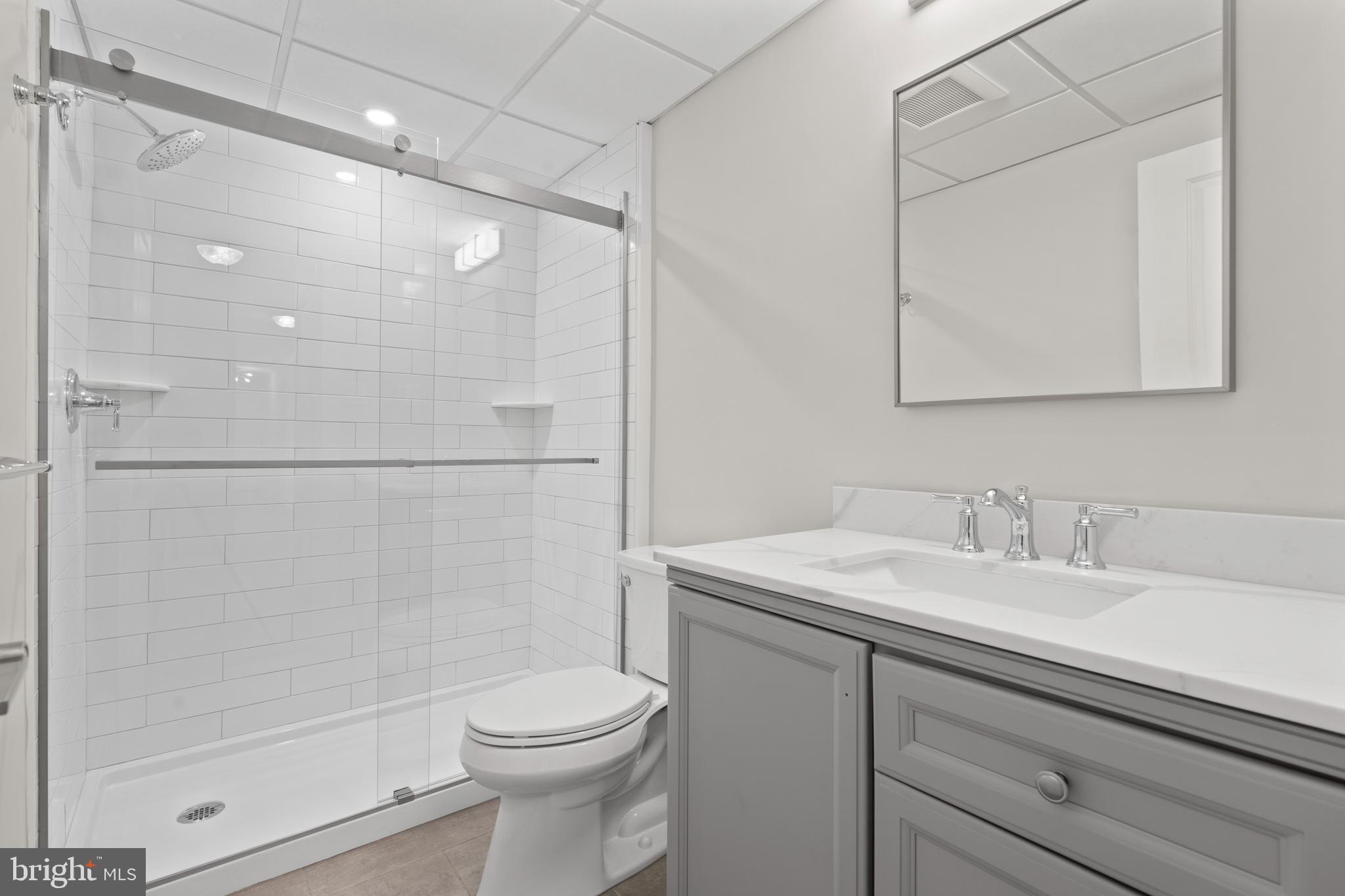 100 Windermere Avenue, Unit 204 Wayne, PA 19087 - Photo 2 of 8 a bathroom with a sink a toilet and shower