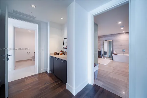 a bathroom with a tub a sink and mirror