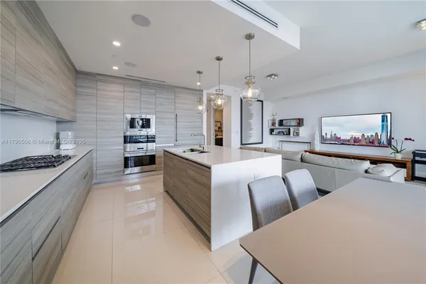 a large room with lots of counter space and chandelier
