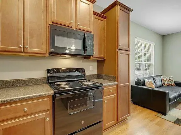 a kitchen with stainless steel appliances granite countertop a stove and a microwave
