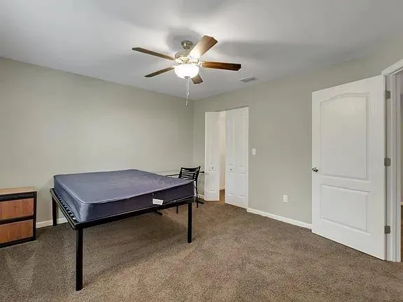 a room with wooden floor and pool table