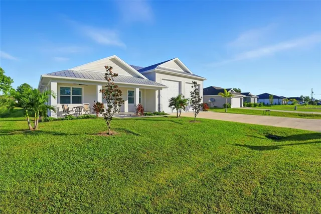 a front view of a house with a yard and trees