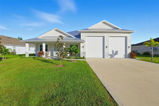 a front view of a house with a yard and porch