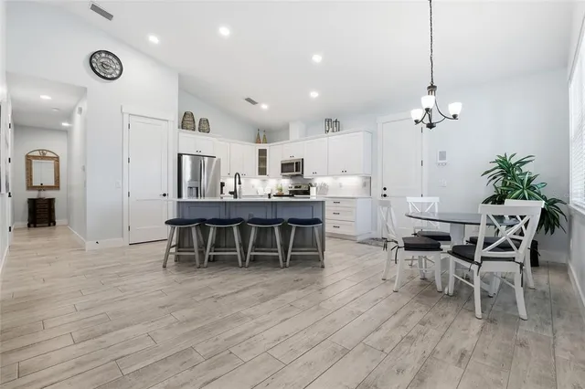 a dining room with furniture and wooden floor