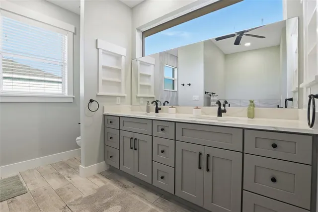 a bathroom with double sink and a mirror