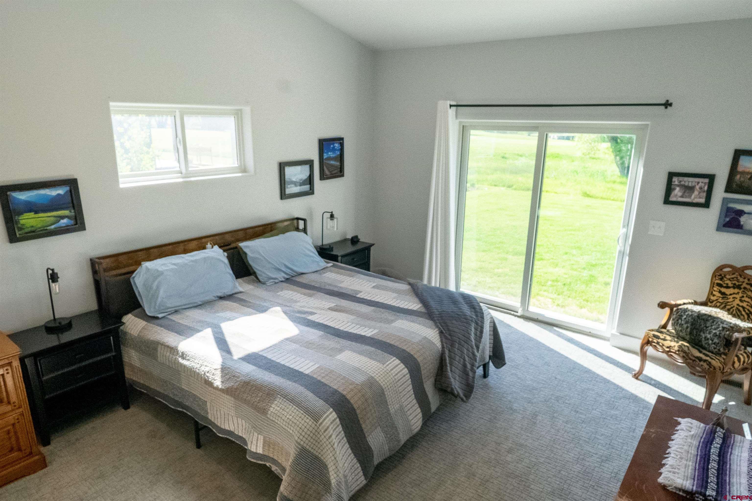 382 Tomichi Trail Gunnison, CO 81230 - Photo 17 of 34 a bedroom with a bed and a window