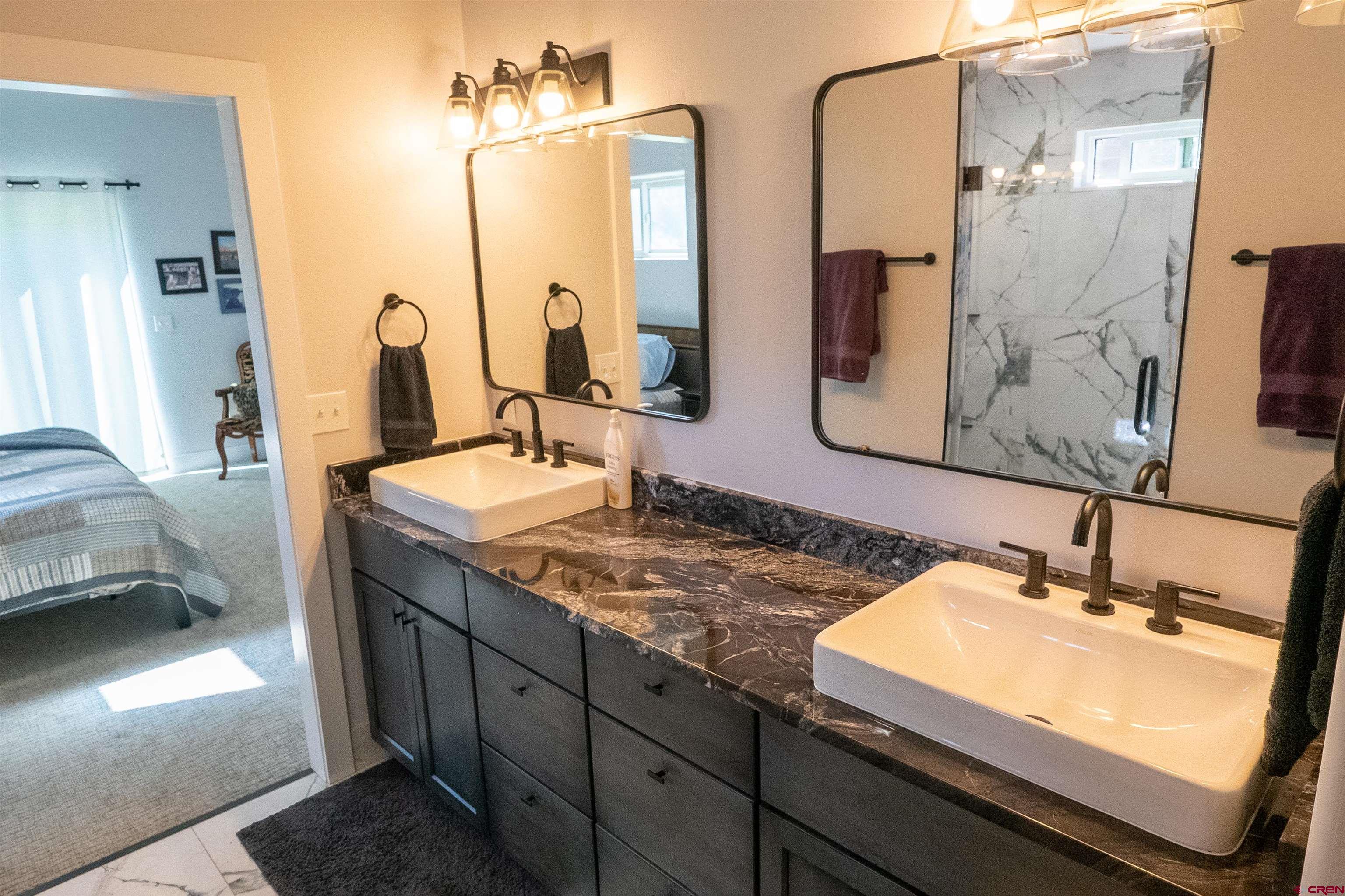 382 Tomichi Trail Gunnison, CO 81230 - Photo 18 of 34 a bathroom with double vanity and a mirror