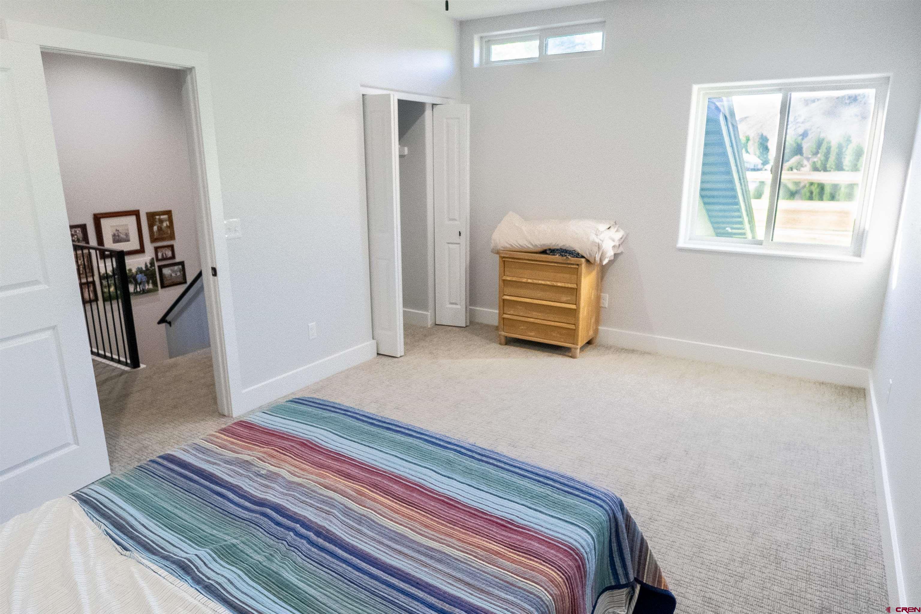 382 Tomichi Trail Gunnison, CO 81230 - Photo 20 of 34 a bedroom with a bed and a window