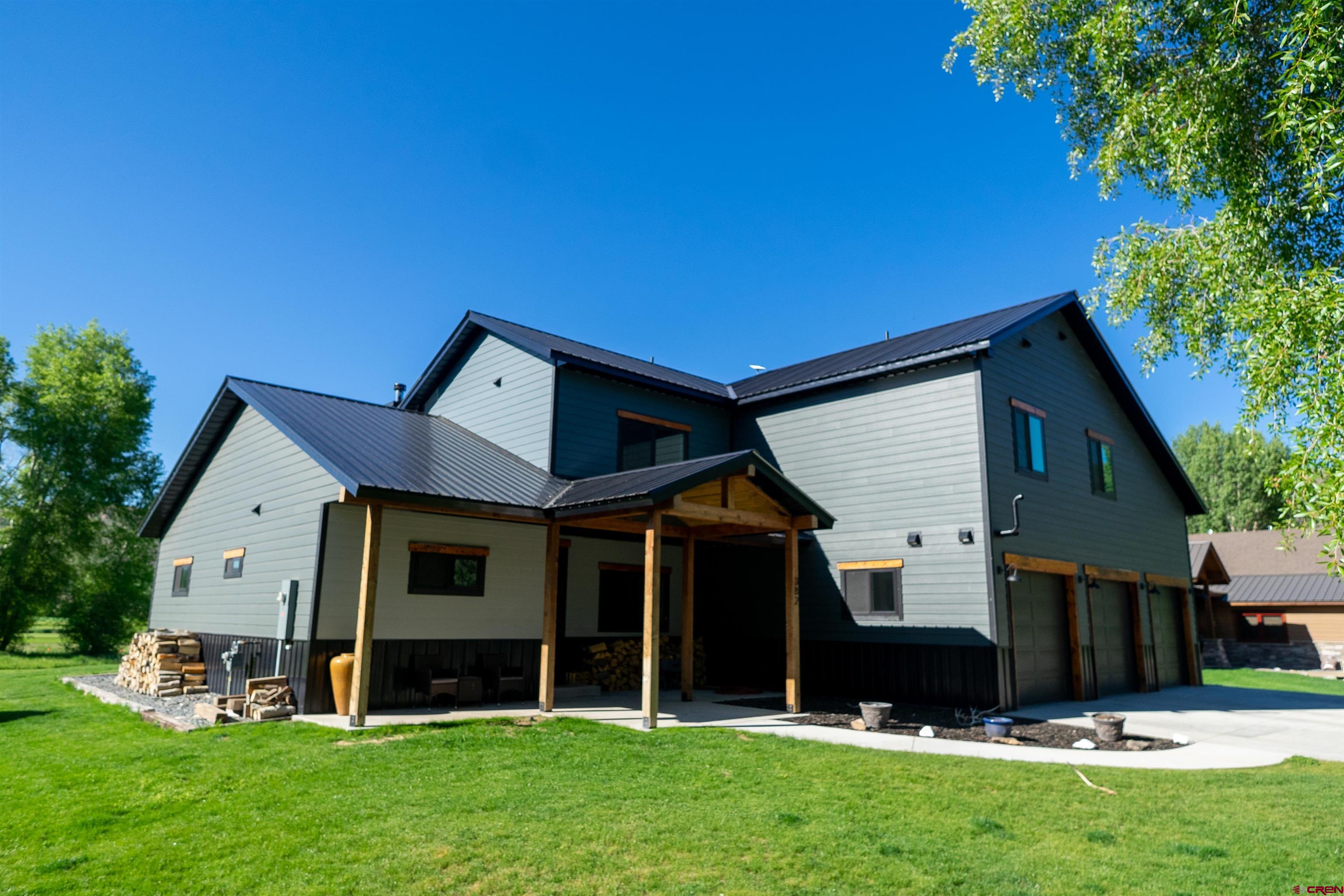 382 Tomichi Trail Gunnison, CO 81230 - Photo 2 of 34 a front view of house with yard and green space
