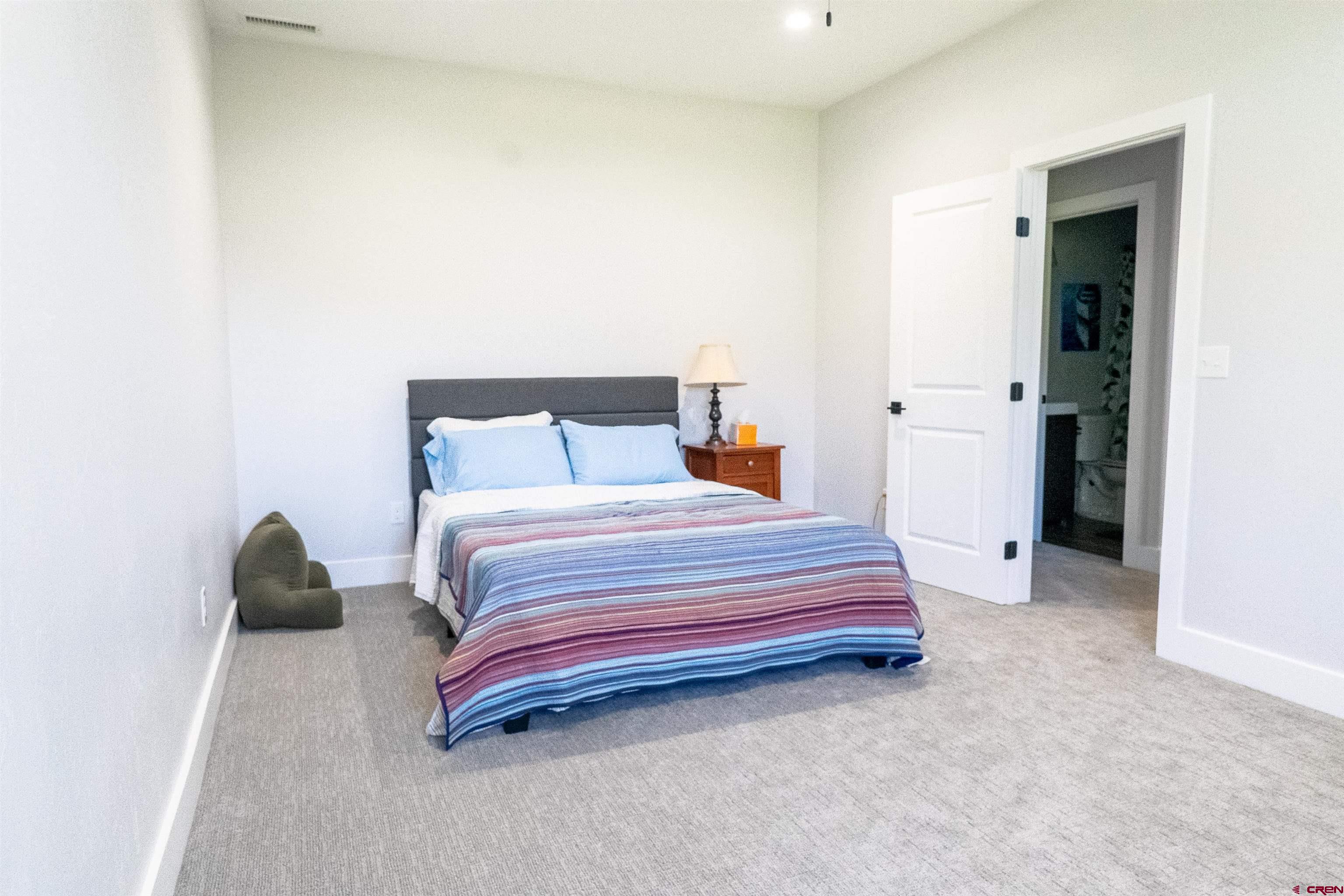 382 Tomichi Trail Gunnison, CO 81230 - Photo 21 of 34 a bedroom with a bed and a window