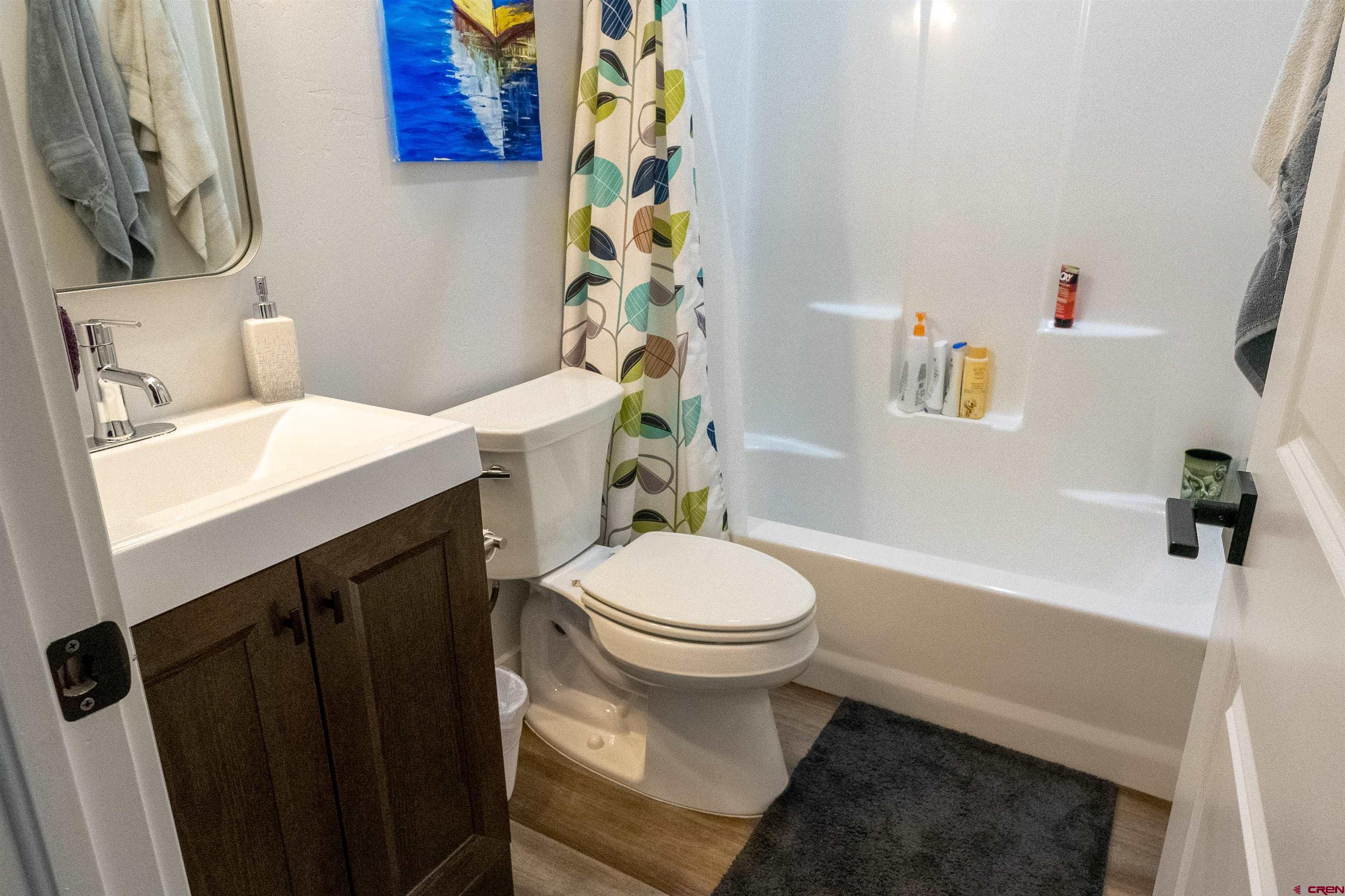 382 Tomichi Trail Gunnison, CO 81230 - Photo 26 of 34 a bathroom with a sink a toilet and shower curtain