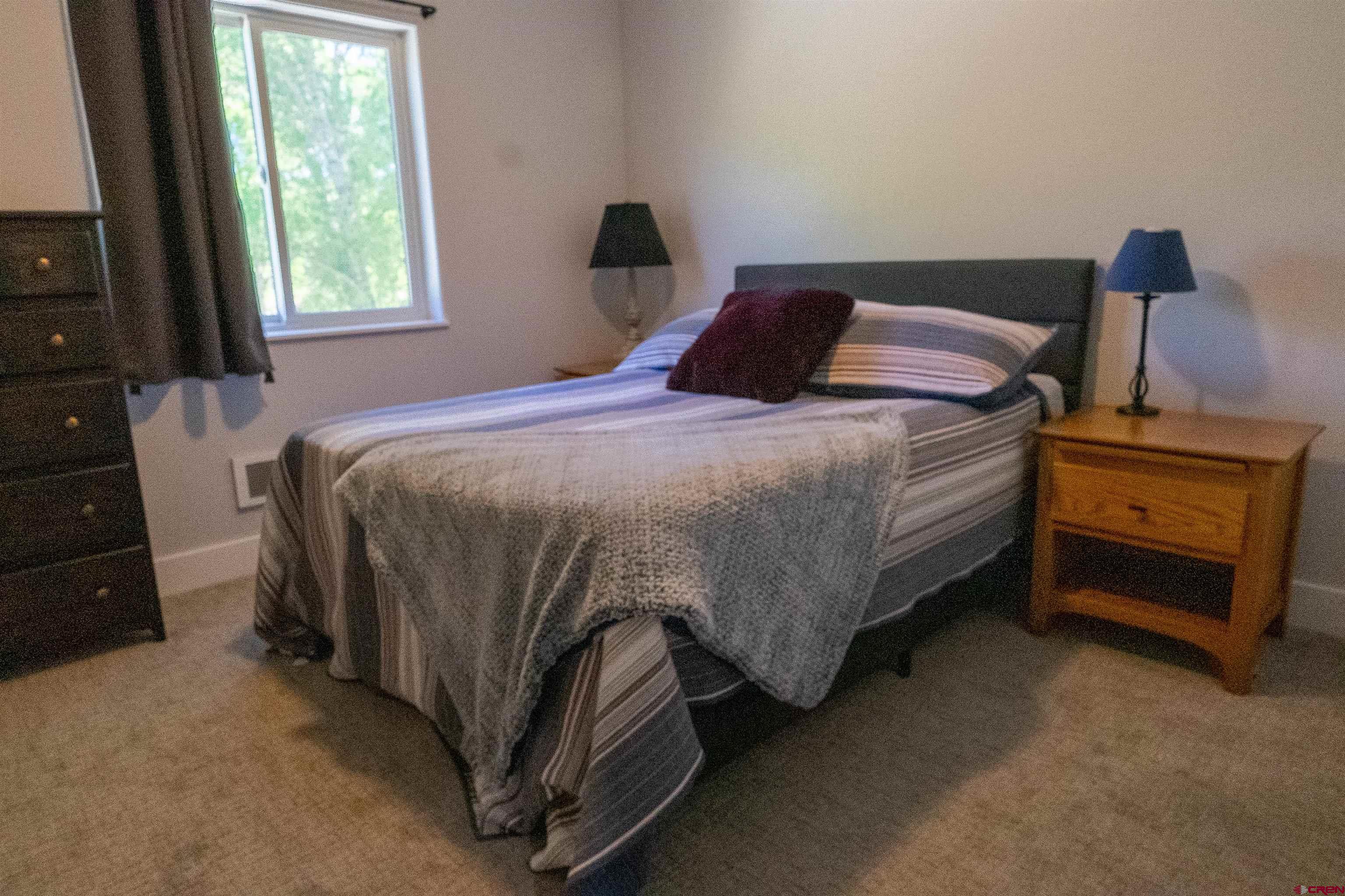382 Tomichi Trail Gunnison, CO 81230 - Photo 29 of 34 a bedroom with a bed and a window
