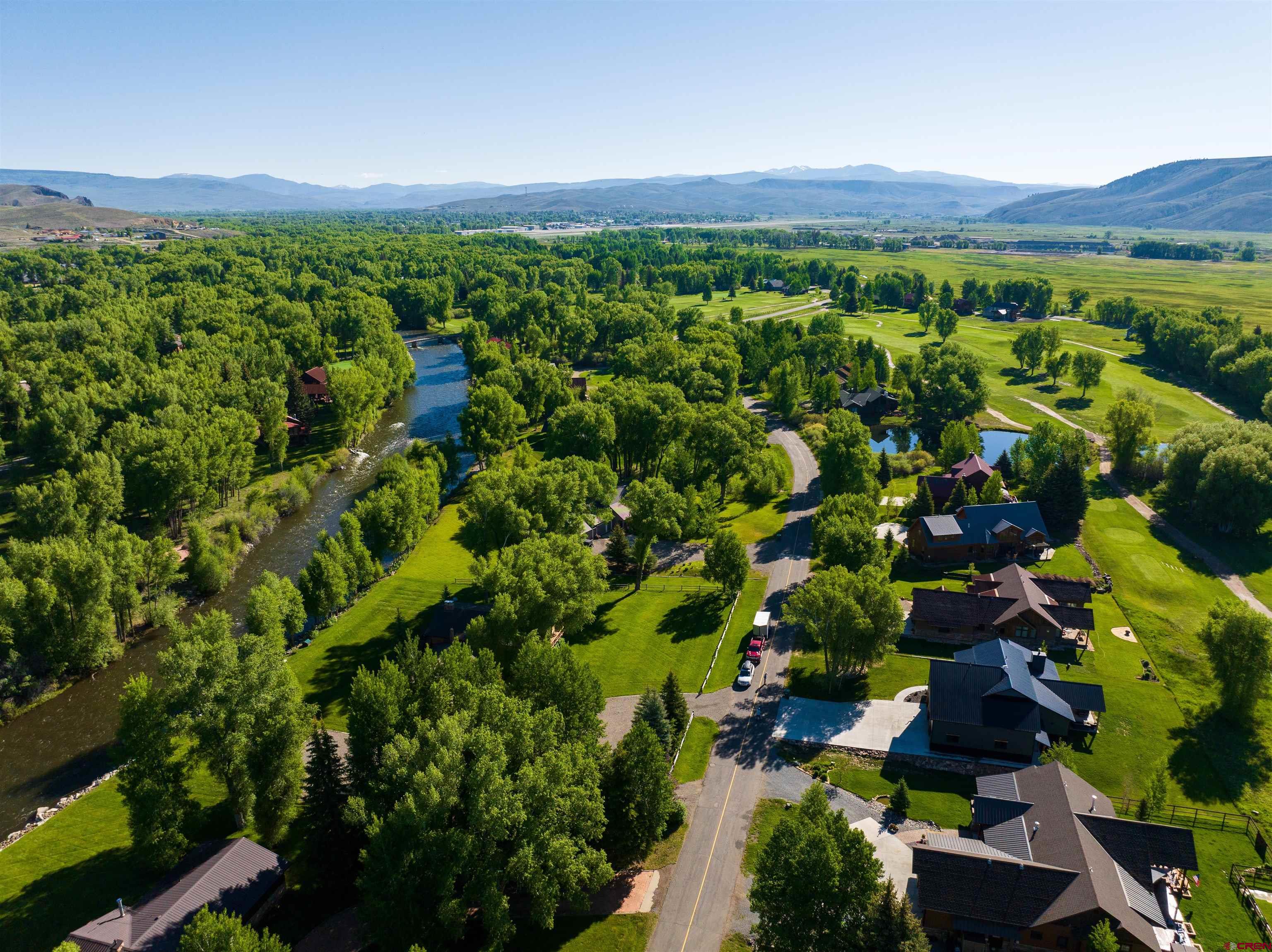 382 Tomichi Trail Gunnison, CO 81230 - Photo 9 of 34 a view of a lush green field with lots of plants in it