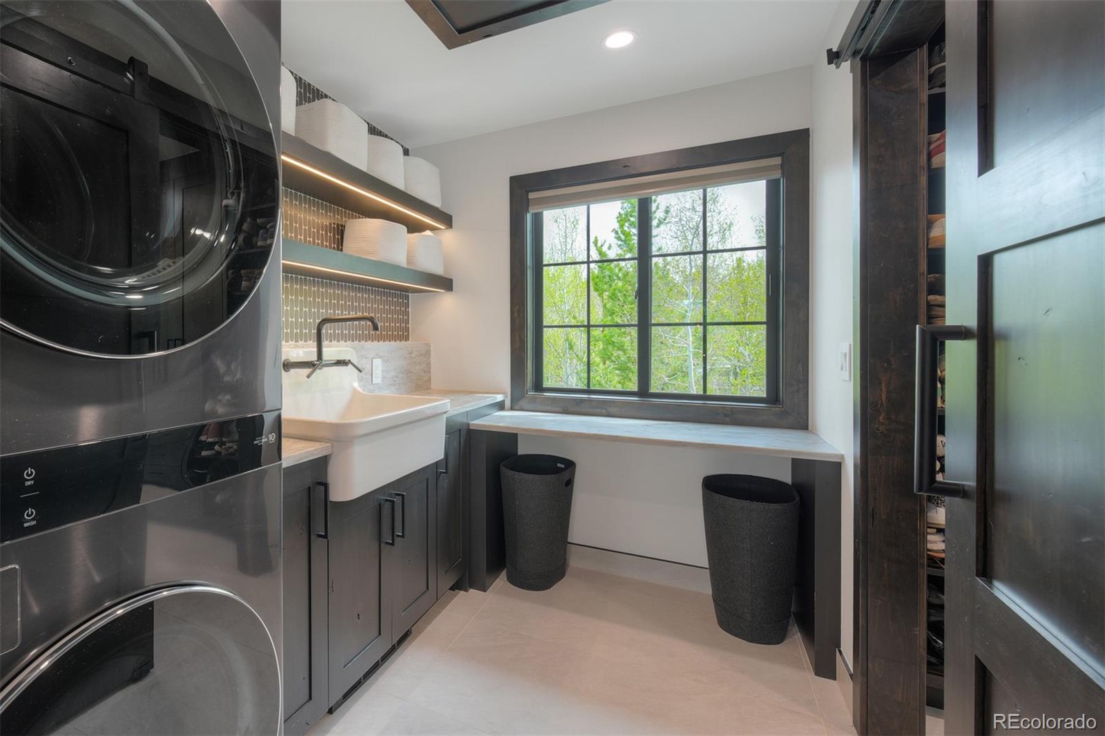 306 Golden Eagle Road Silverthorne, CO 80498 - Photo 26 of 43 a bathroom with a sink a washer and dryer next to a window