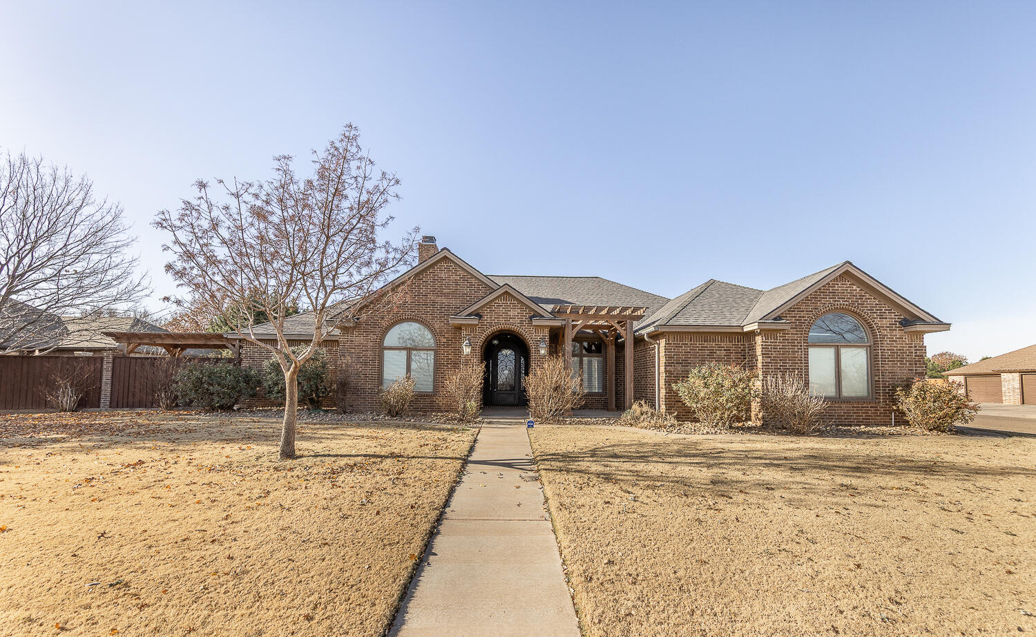 11302 Juneau Avenue Lubbock, TX 79424 - Photo 1 of 49 a front view of a house with a yard covered in snow