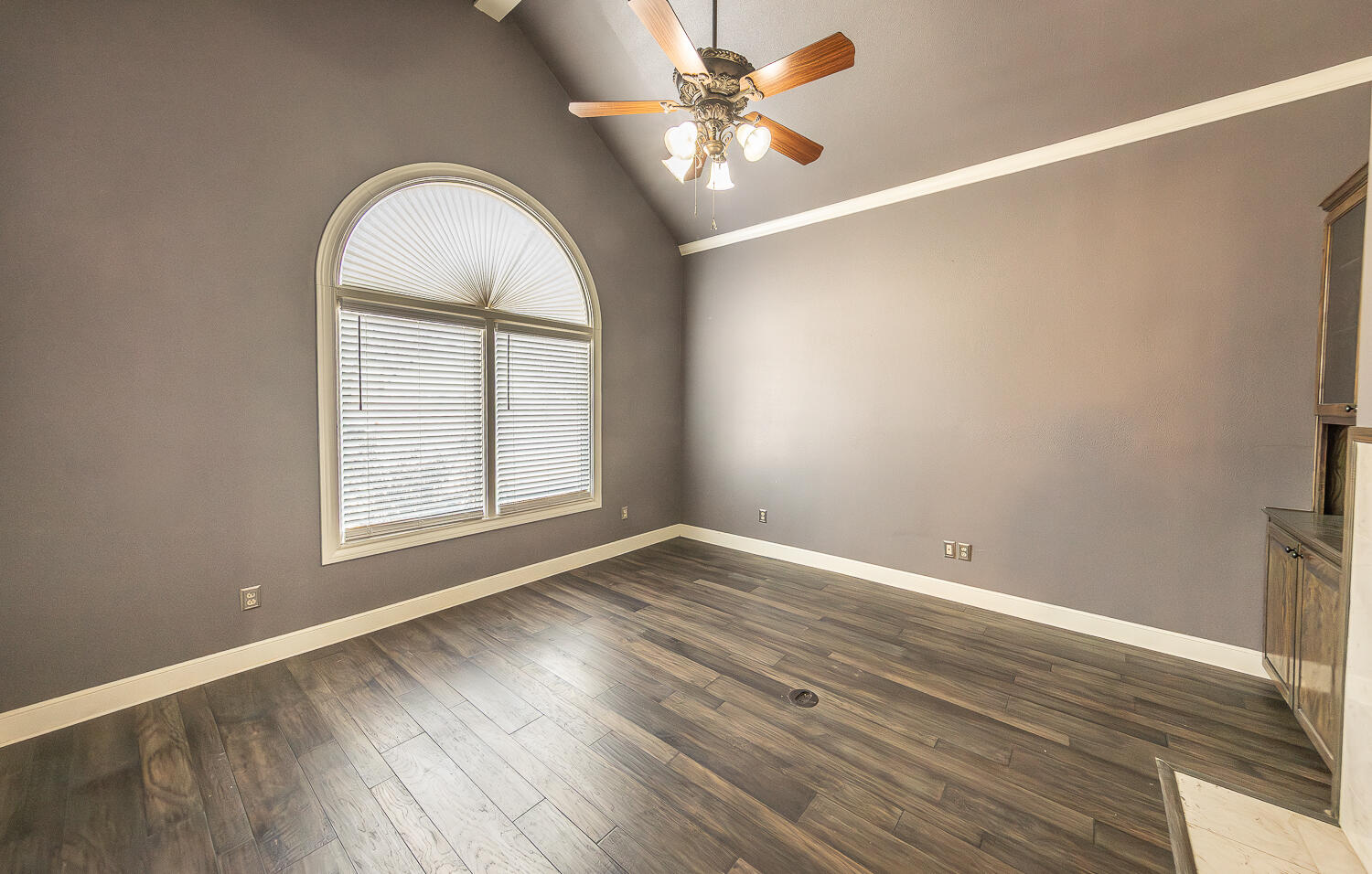 11302 Juneau Avenue Lubbock, TX 79424 - Photo 18 of 49 an empty room with wooden floor and windows