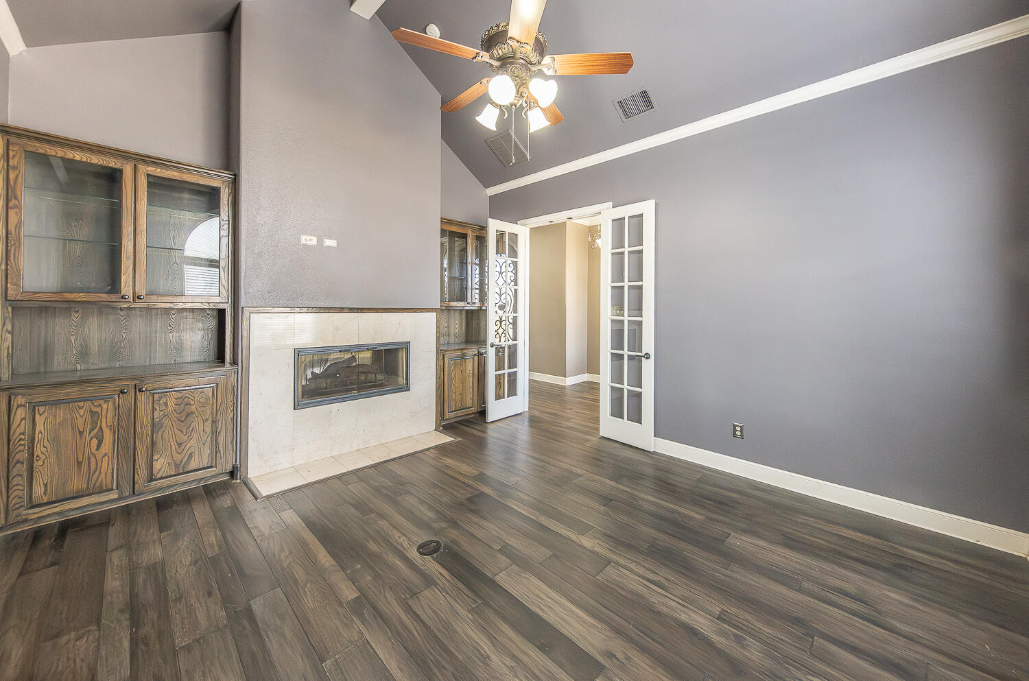 11302 Juneau Avenue Lubbock, TX 79424 - Photo 19 of 49 wooden floor in an empty room with a fireplace